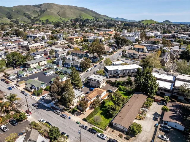 an aerial view of residential houses with city view