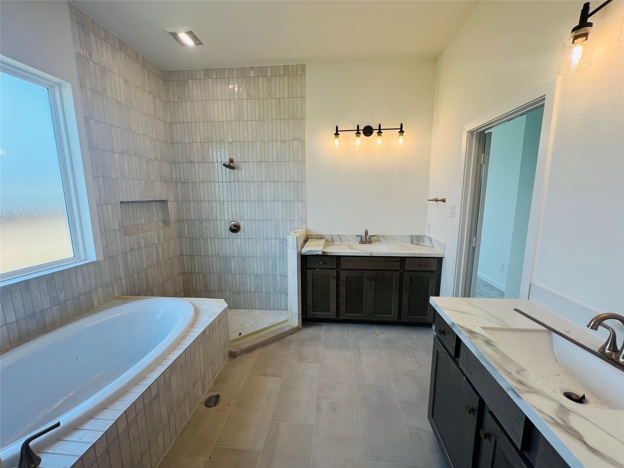 8725 Antelope Cyn Way Manvel, TX 77578 - Photo 5 of 29 a bathroom with a double vanity sink a toilet a mirror and shower