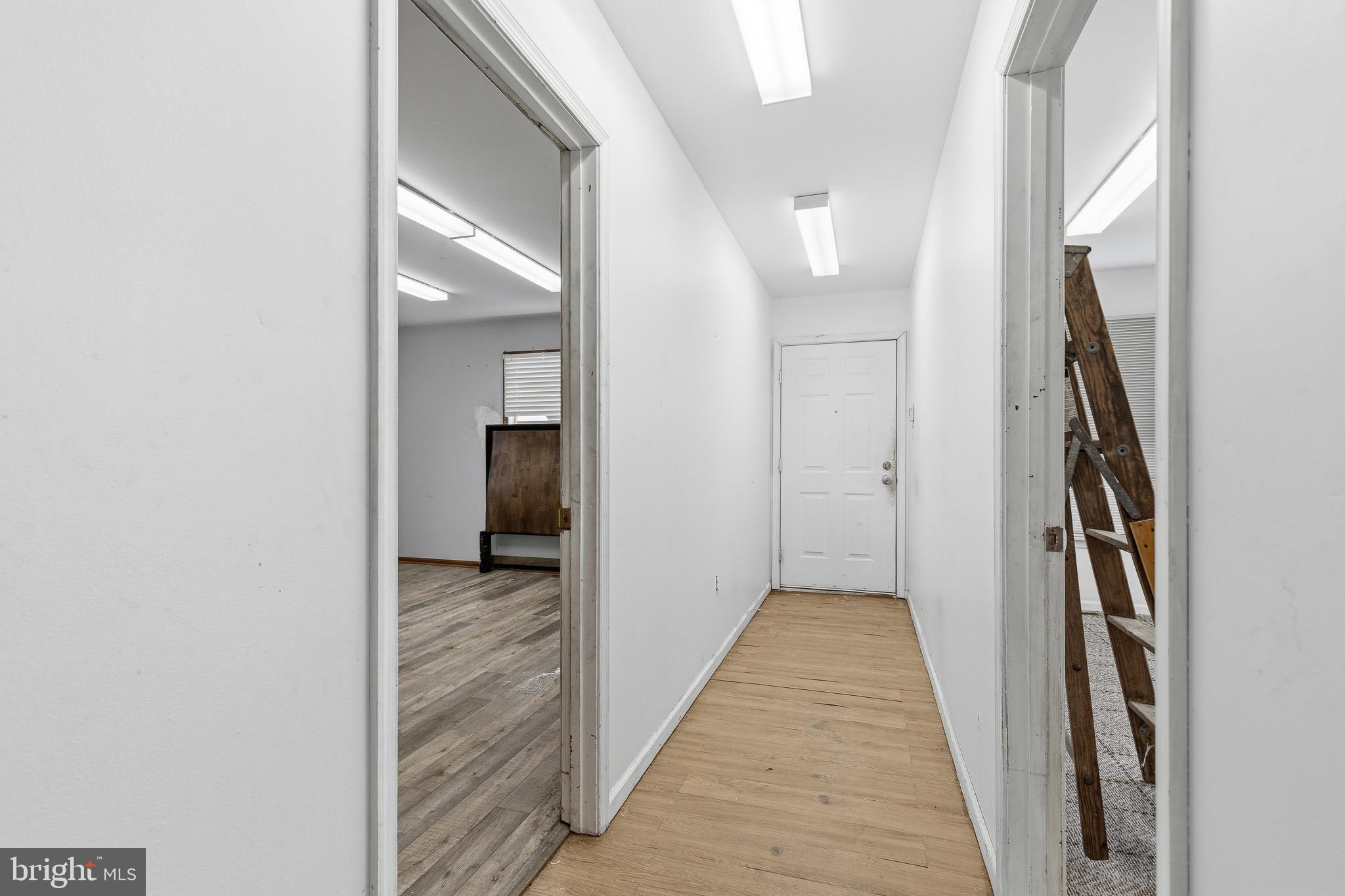 212 West Main Street Elkton, MD 21921 - Photo 22 of 35 a view of a hallway with wooden floor and a bathroom