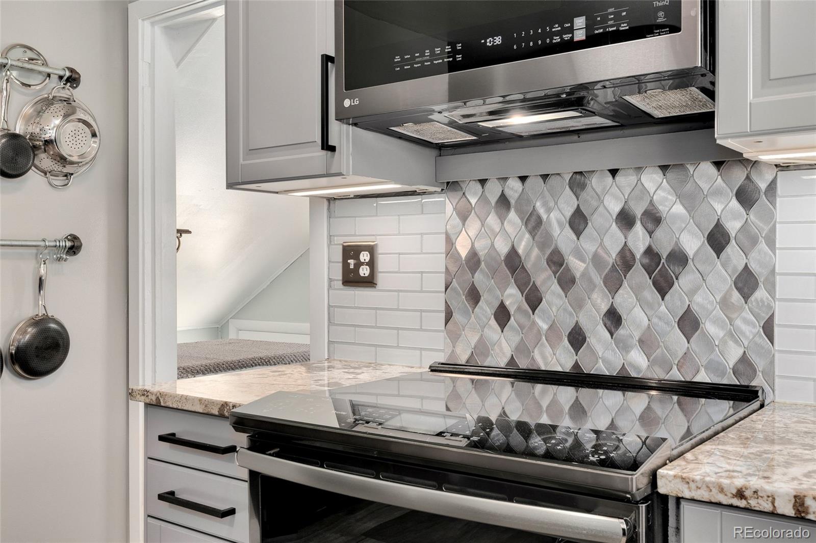 1530 Simms Street Lakewood, CO 80215 - Photo 11 of 38 a bathroom with a granite countertop sink and a mirror