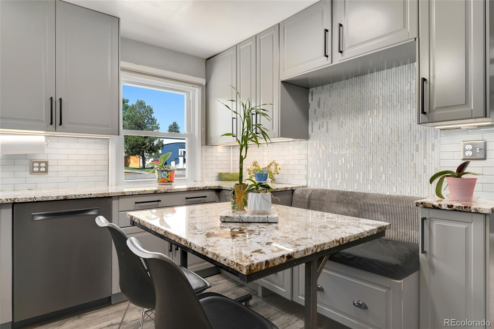 1530 Simms Street Lakewood, CO 80215 - Photo 12 of 38 a kitchen with granite countertop stainless steel appliances a sink and cabinets