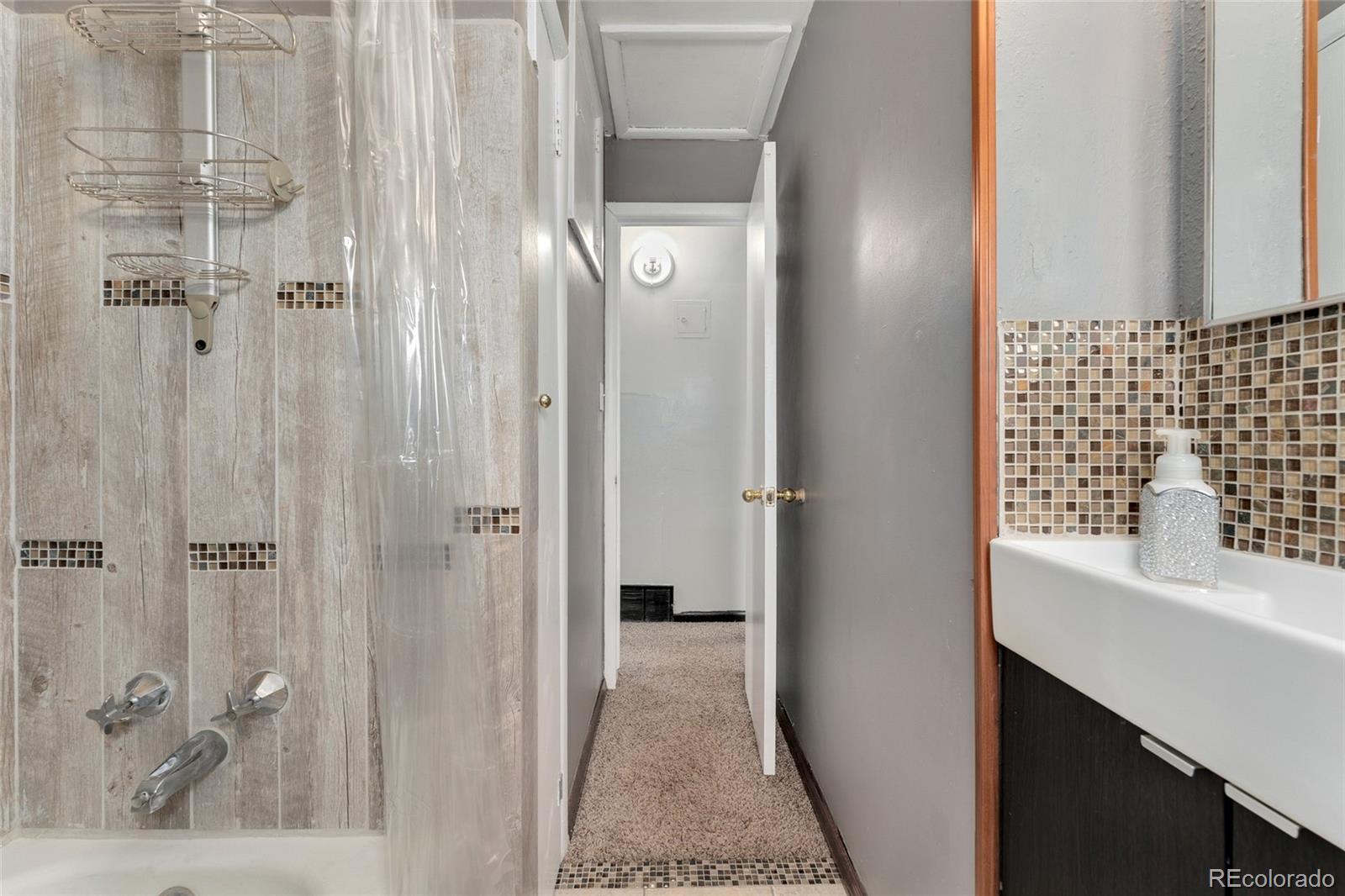 1530 Simms Street Lakewood, CO 80215 - Photo 14 of 38 a bathroom with a sink and a mirror