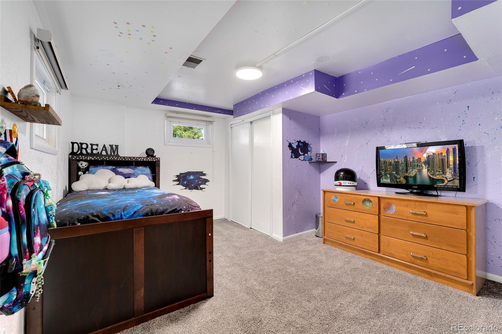 1530 Simms Street Lakewood, CO 80215 - Photo 20 of 38 a bed room with a bed and a television