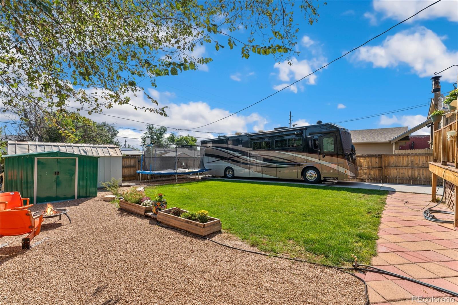 1530 Simms Street Lakewood, CO 80215 - Photo 27 of 38 a view of a backyard with couches plants and large trees