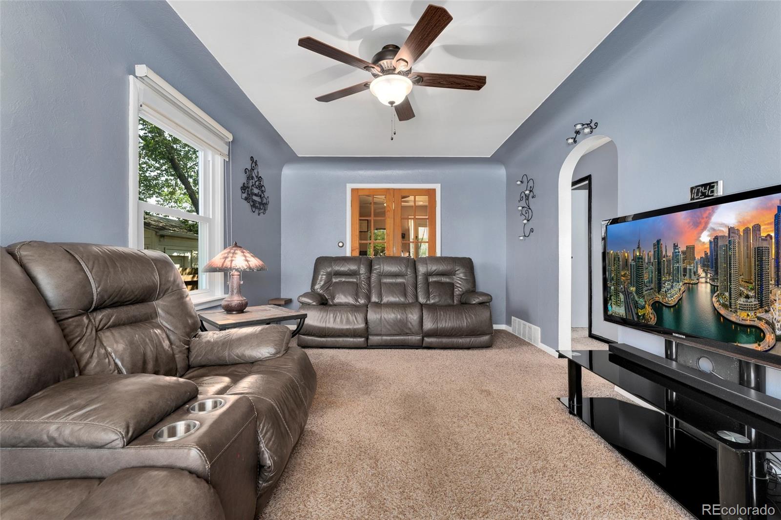 1530 Simms Street Lakewood, CO 80215 - Photo 7 of 38 a living room with furniture and a flat screen tv