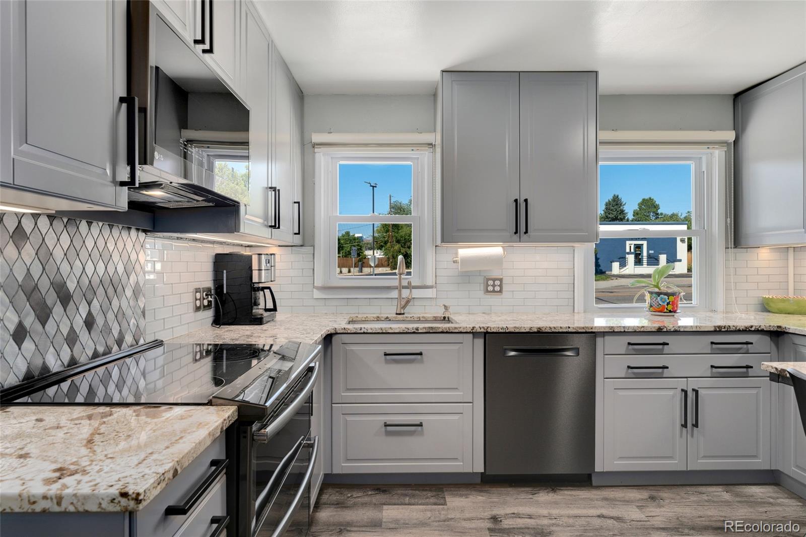 1530 Simms Street Lakewood, CO 80215 - Photo 10 of 38 a kitchen with a sink stove and cabinets