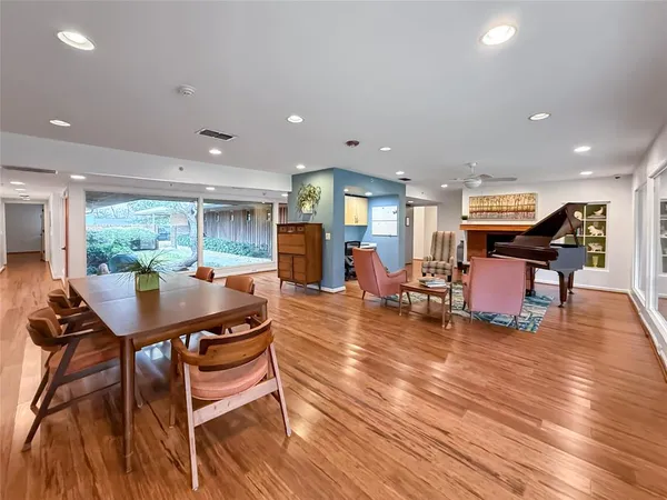 a dining room with furniture and wooden floor