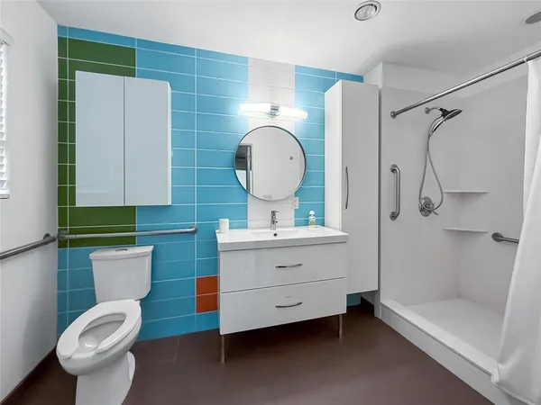 a bathroom with a toilet sink and mirror