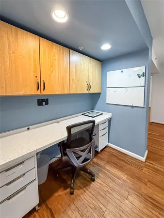 a kitchen with a sink cabinets and wooden floor