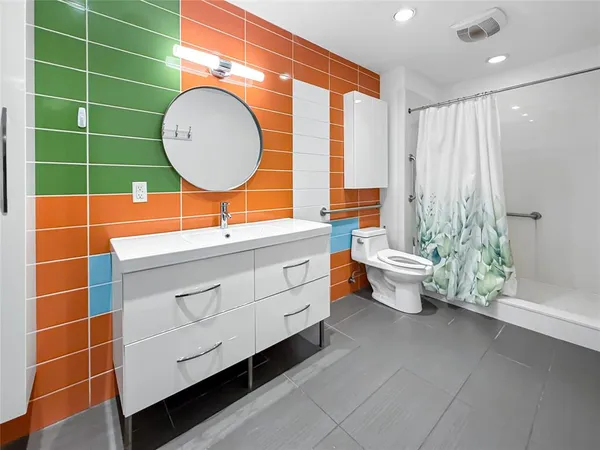 a bathroom with a sink mirror toilet and shower