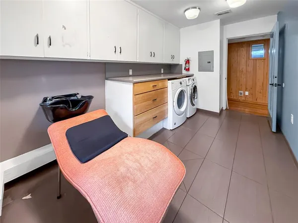 a kitchen with stainless steel appliances a stove a refrigerator white cabinets and a sink