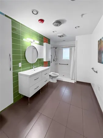a room with a chair and cabinets