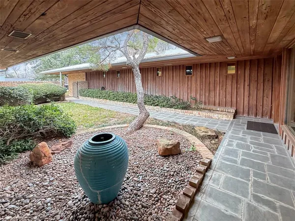 a view of a backyard with table and chairs with wooden fence