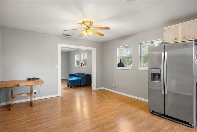 a view of a livingroom with furniture and a fan