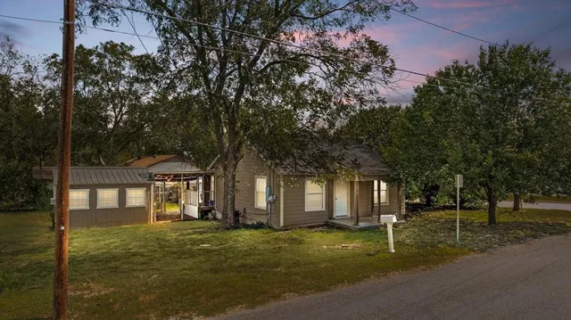 a front view of a house with a garden