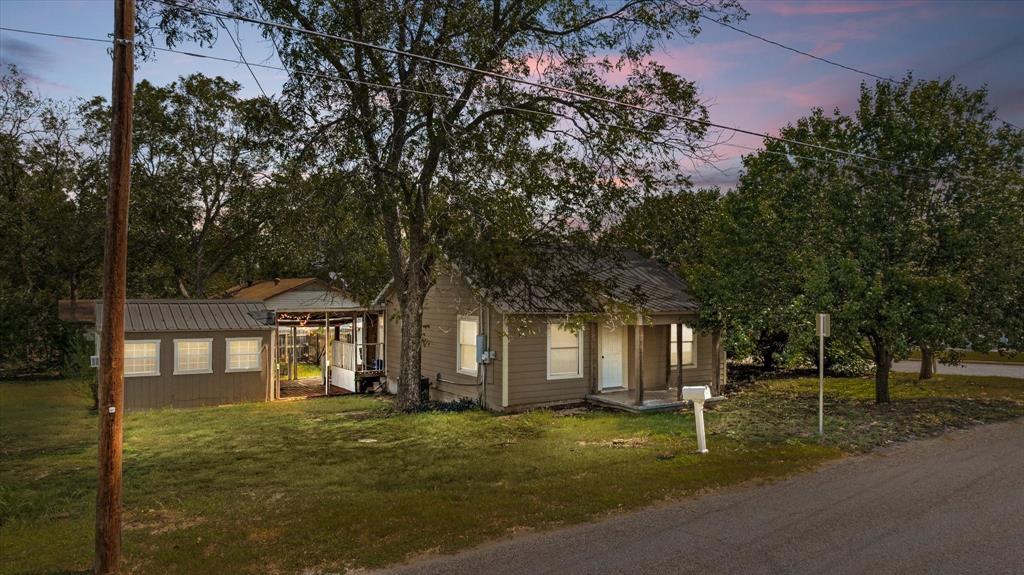 625 South Lillian Stephenville, TX 76401 - Photo 2 of 34 a front view of a house with a garden