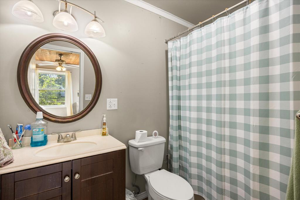 625 South Lillian Stephenville, TX 76401 - Photo 24 of 34 a bathroom with a sink a toilet and a mirror