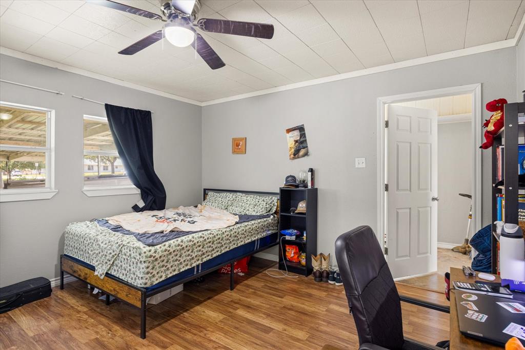 625 South Lillian Stephenville, TX 76401 - Photo 26 of 34 a bedroom that has a bed and a table in it