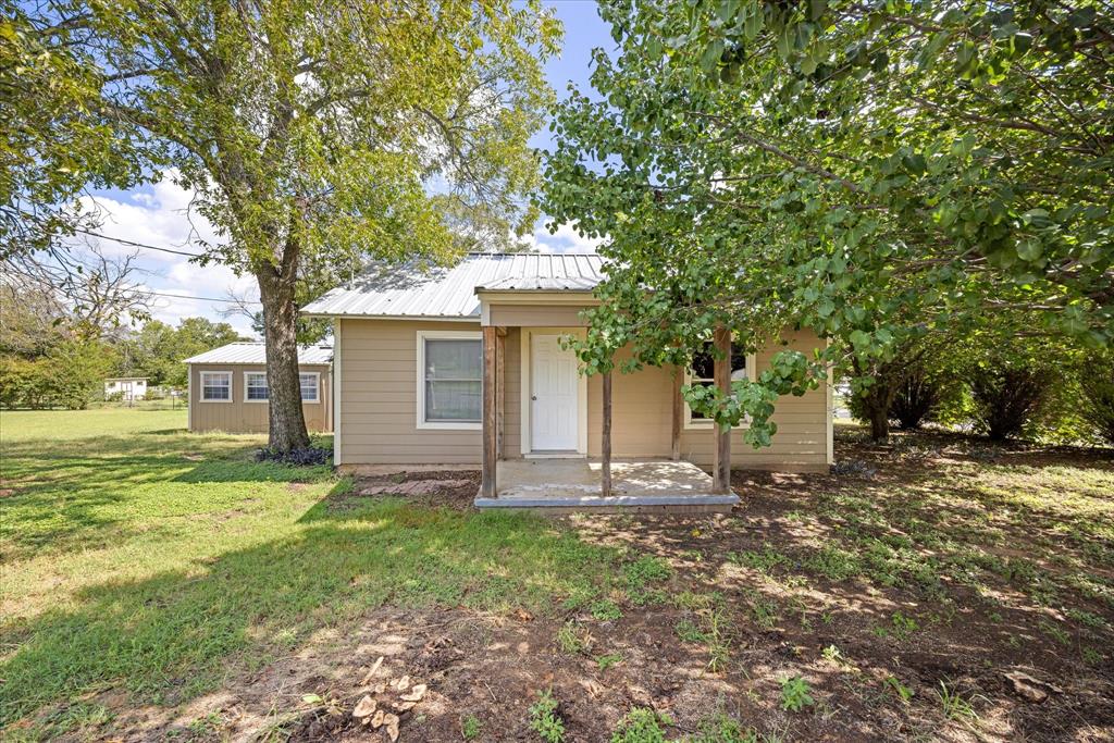 625 South Lillian Stephenville, TX 76401 - Photo 3 of 34 a front view of a house with garden