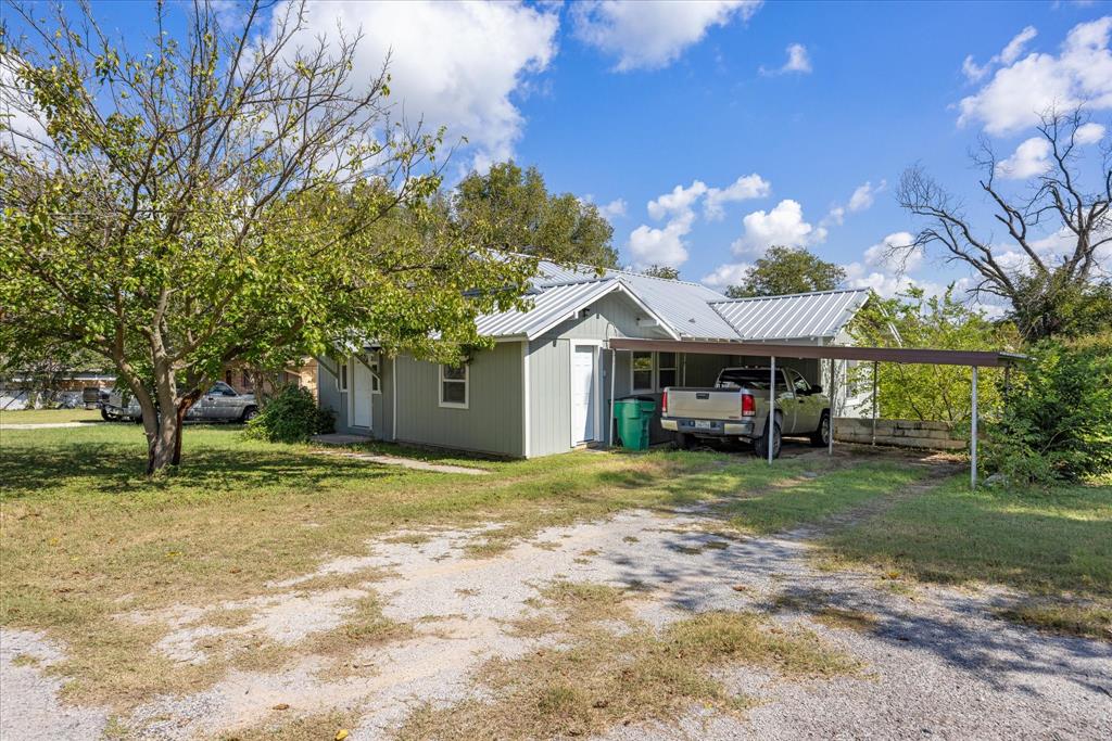 625 South Lillian Stephenville, TX 76401 - Photo 29 of 34 a front view of a house with a yard and garage