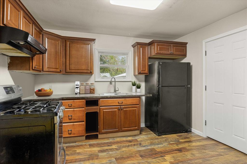 625 South Lillian Stephenville, TX 76401 - Photo 5 of 34 a kitchen with stainless steel appliances granite countertop a refrigerator sink and stove