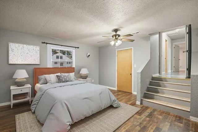 a spacious bedroom with a bed and a chandelier