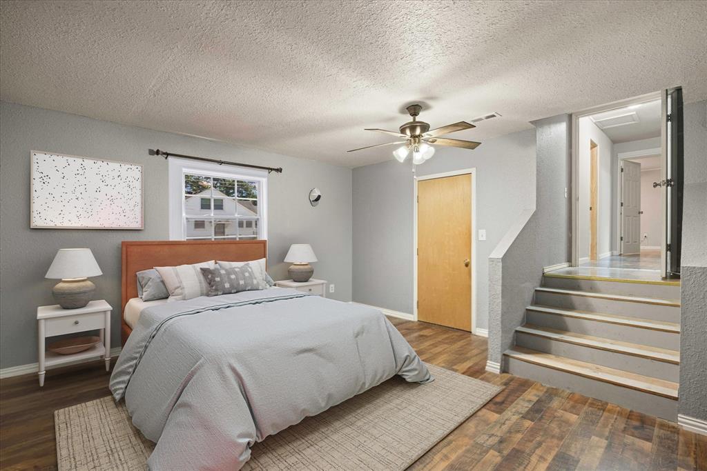 625 South Lillian Stephenville, TX 76401 - Photo 6 of 34 a spacious bedroom with a bed and a chandelier