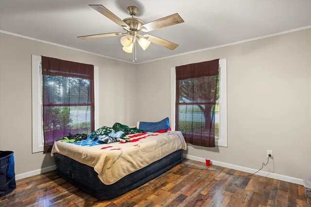 a bedroom with a large bed and a window
