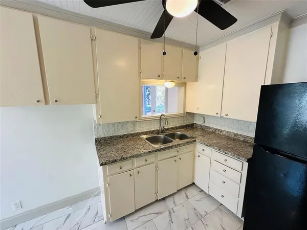 a kitchen with a sink and a refrigerator