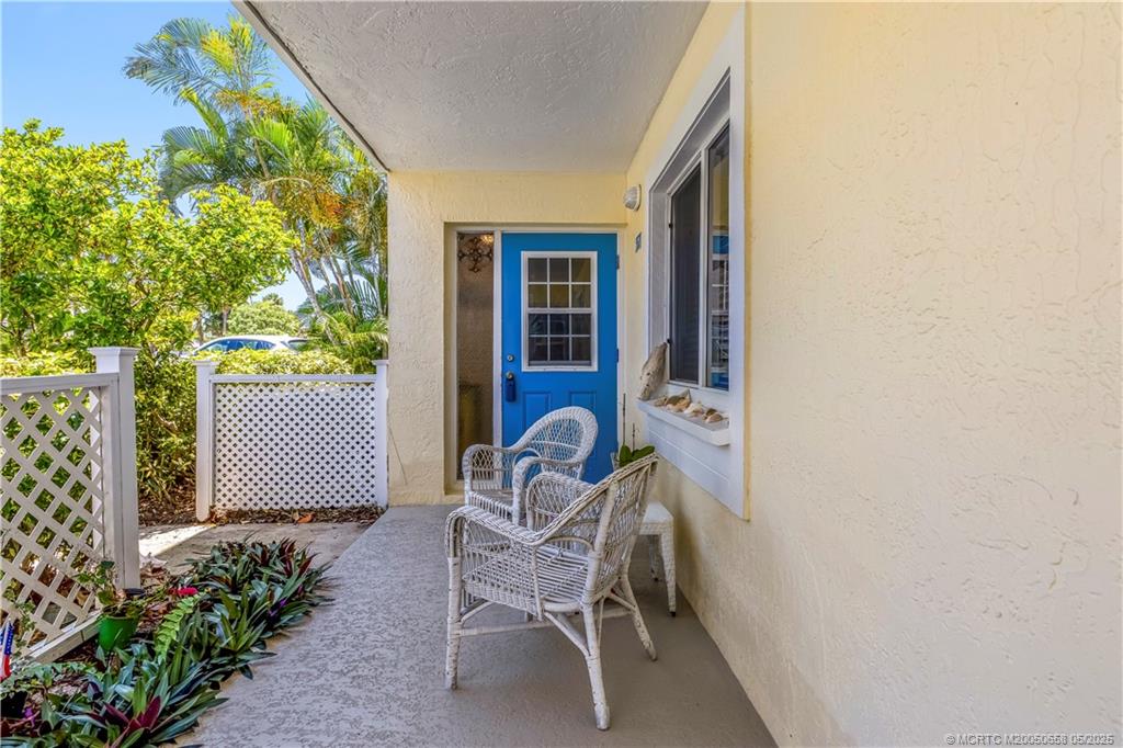 5571 Northeast Gulfstream Way Stuart, FL 34996 - Photo 11 of 40 a chair and table in a backyard
