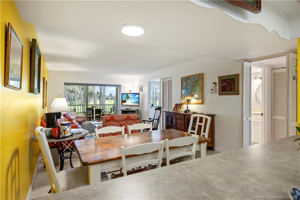 5571 Northeast Gulfstream Way Stuart, FL 34996 - Photo 15 of 40 a living room with furniture and a large window