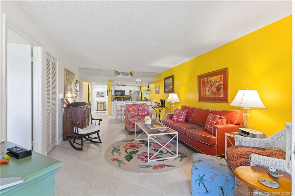 5571 Northeast Gulfstream Way Stuart, FL 34996 - Photo 22 of 40 a living room with furniture a flat screen tv and a window