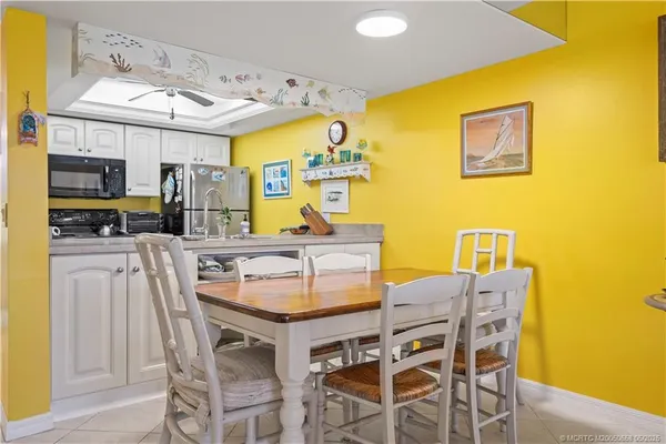 a view of a dining room with furniture and a kitchen