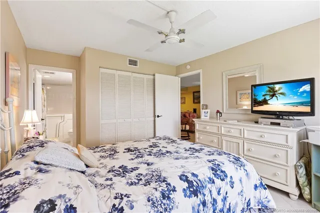 a bedroom with a bed and a flat screen tv in it