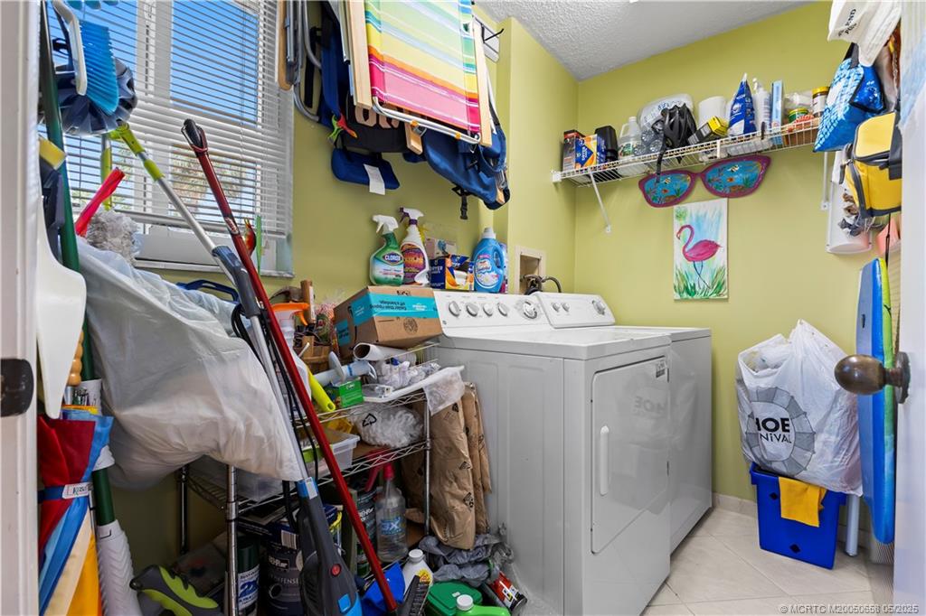 5571 Northeast Gulfstream Way Stuart, FL 34996 - Photo 31 of 40 a utility room with dryer and washer