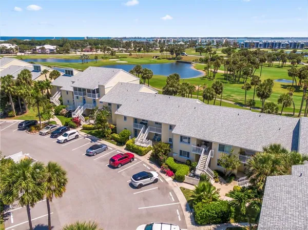 an aerial view of a residential houses with swimming pool