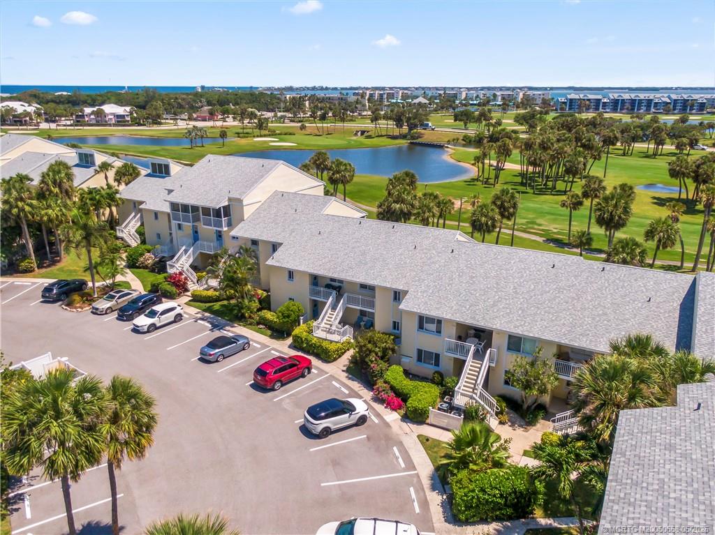 5571 Northeast Gulfstream Way Stuart, FL 34996 - Photo 34 of 40 an aerial view of residential houses with outdoor space and lake view
