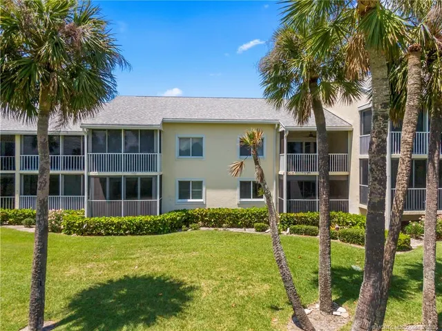 a view of a golf course with a ocean view