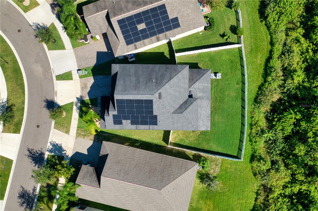 an aerial view of a house with a garden and swimming pool