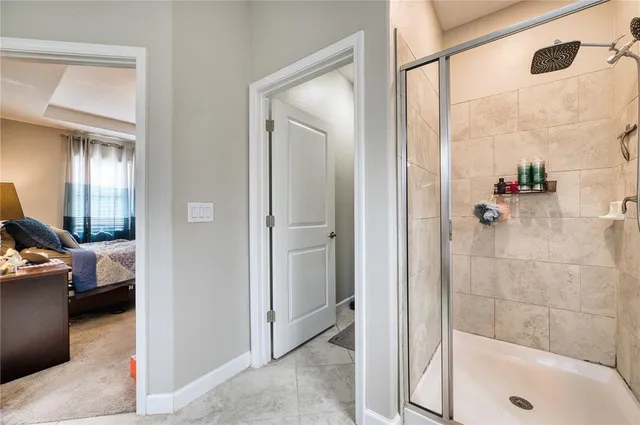a bathroom with a glass shower door
