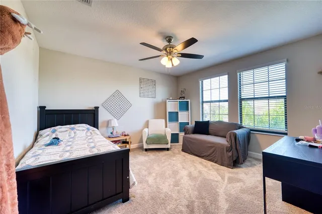 a bedroom with furniture and a large window