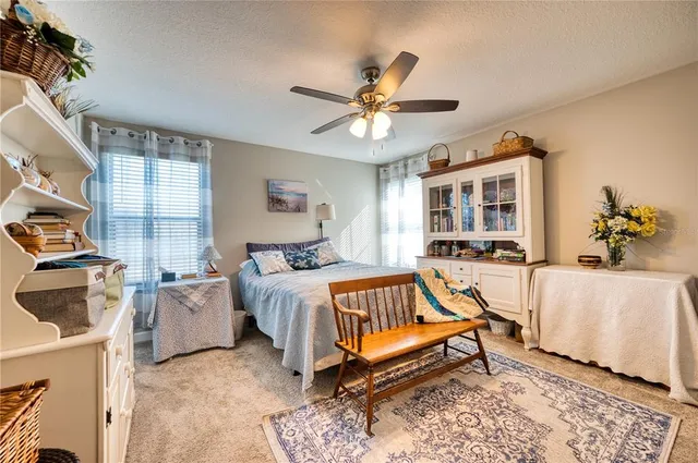 a spacious bedroom with a bed and a chandelier