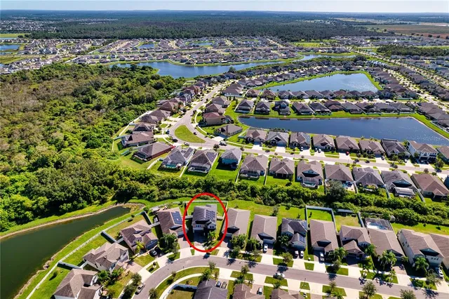 an aerial view of residential houses with outdoor space