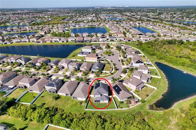 an aerial view of residential house with outdoor space and swimming pool