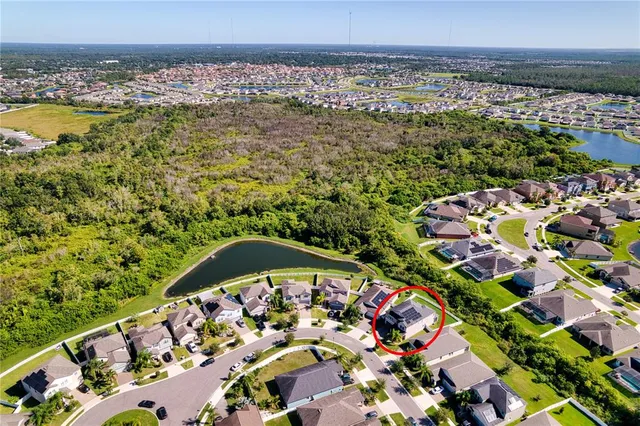 an aerial view of a house with a garden and outdoor space