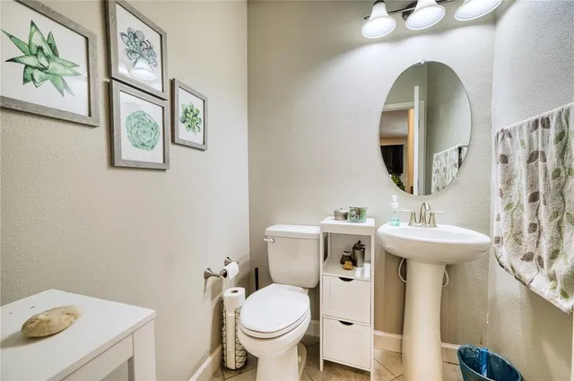 a bathroom with a toilet a sink and a mirror