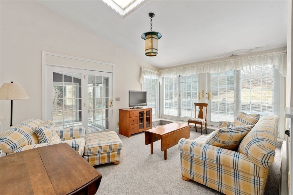 422 Liberty Square Road Boxborough, MA 01719 - Photo 1 of 39 a living room with furniture and floor to ceiling windows