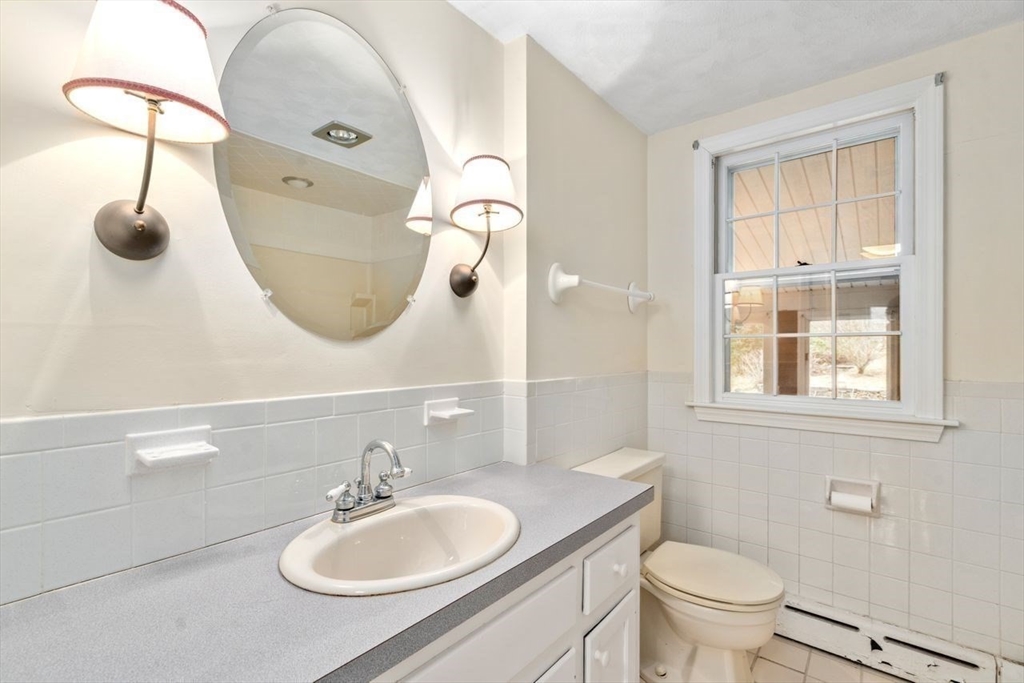 422 Liberty Square Road Boxborough, MA 01719 - Photo 16 of 39 a bathroom with a sink a toilet and a mirror