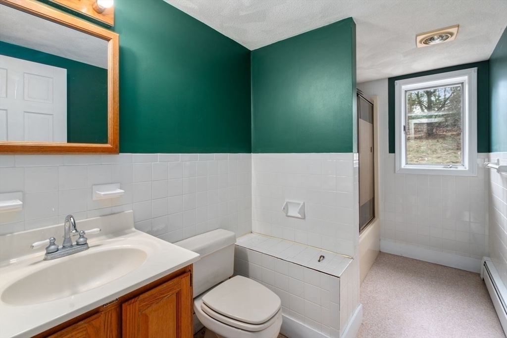 422 Liberty Square Road Boxborough, MA 01719 - Photo 21 of 39 a bathroom with a toilet sink and mirror