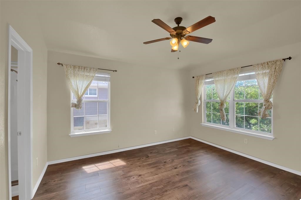 1900 Scofield Ridge Parkway, Unit 3401 Austin, TX 78727 - Photo 24 of 37 a view of an empty room with wooden floor and a window